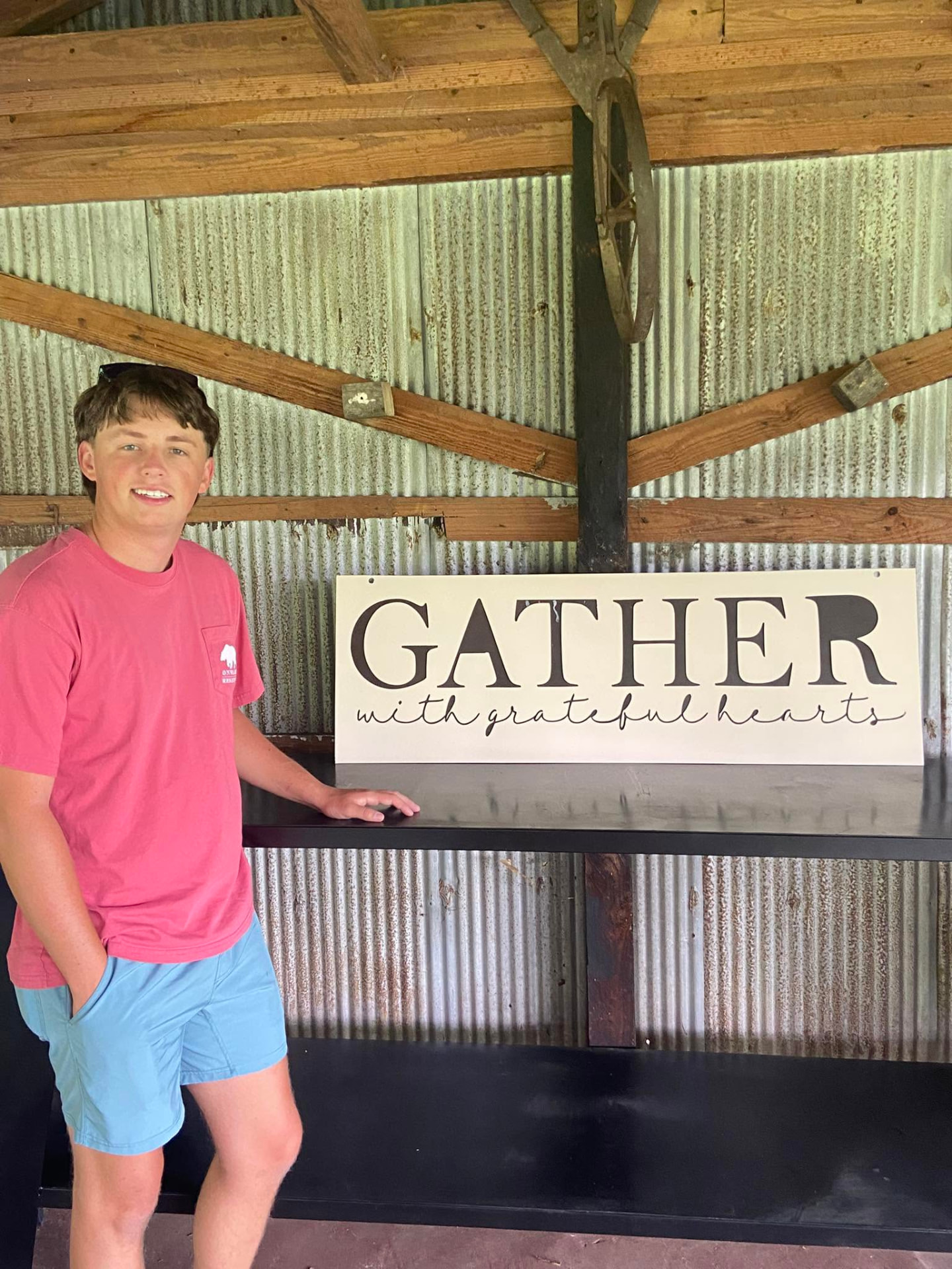 Gather with grateful hearts metal sign on a steel bar top