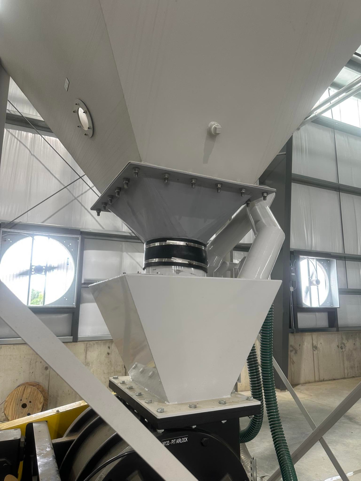 Fabricated hopper and chute assembly installed in a facility